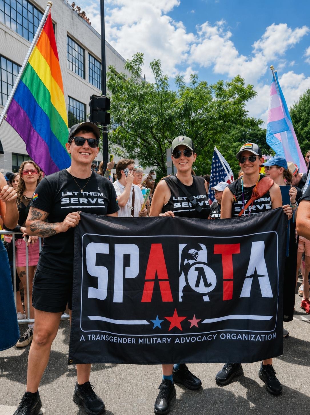 Emily Shilling and SPARTA Pride members at Pride parade holding SPARTA banner